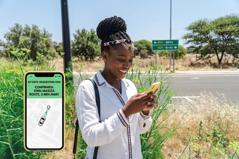 A passenger on a roadside checking her confirmed ride on the As'Vaye app